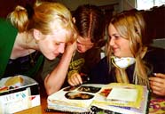 My nieces and nephew, looking at a sketchbook.