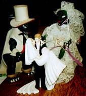 Two generations of wedding cake toppers.Susan Shie 2000.