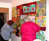 Sara and Carol Mac working on quilt. Susan Shie 2003.