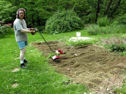 Jimmy tills the garden.Susan Shie 2005.