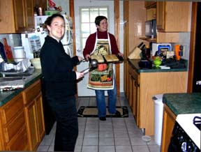 Gretchen and Kristi cooking T Day dinner.Susan Shie 2004.
